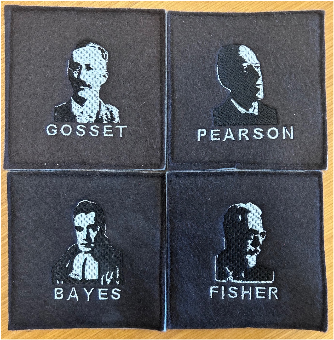 A set of four coasters including Gosset, Pearson, Bayes, and Fisher